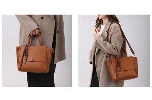 Detail van bruine tote bag met litchi-patroon, handvaten en afneembare schouderriem