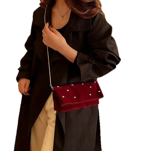 Retro burgundy velvet shoulder bag with silver studs and chain strap shown on model