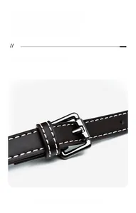 Detail of dark brown leather strap with white stitching and silver metal buckle adjustment