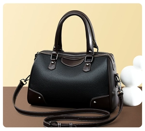 Detailed view of the Boston bag showing black pebbled leather and brown trim contrast