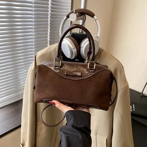 Vintage brown suede handbag with leather bow detail and elegant gold zippers for women