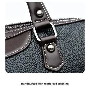 Detailed macro view of reinforced precision stitching on black leather pillow bag handle