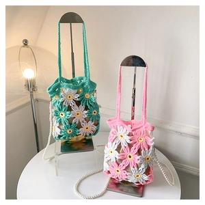 Detail of handmade daisy crochet bag with pearl strap and drawstring inner pouch