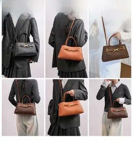 Detail view of woven leather handbag featuring metal X-buckle and cylindrical handle