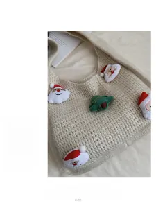 Close-up of beige knitted tote bag featuring festive Santa Claus and tree embroidery