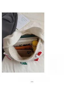 Detail view of large capacity cream knit tote bag showing spacious interior with essentials