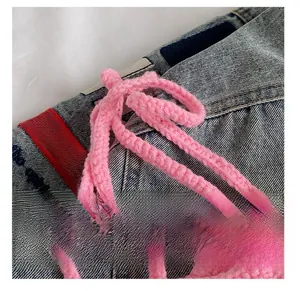 Close-up of pink handmade knitted strap and intricate floral weaving texture