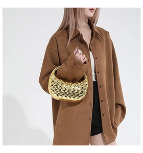 Close-up of golden metallic woven hobo bag with a minimalist chain strap