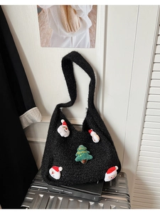 Detail of black knit tote bag featuring 3D Santa heads and Merry Christmas tree patch