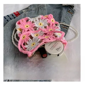 Detail presentation of handmade crochet floral bag showing capacity for phone and cosmetics