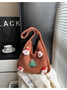 Detail of Christmas themed brown knit tote bag with Santa Claus and festive embroidery