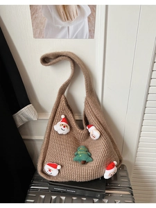 Detail of a brown knitted tote bag with festive 3D Santa and Christmas tree patches