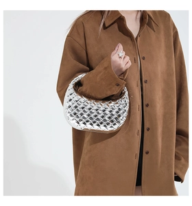 Close-up of metallic silver hand-woven hobo bag with bold texture and modern style