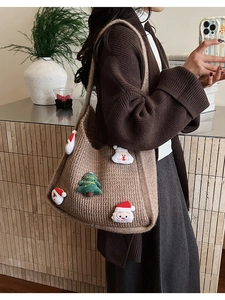 Close-up of thick knitted tote bag featuring a 3D Santa and Merry Christmas tree patch