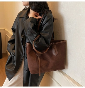 Deep brown suede tote bag styled with a leather coat for a modern workplace commute look