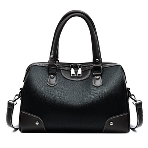 Classic black lychee leather pillow bag with brown trim and silver metal accents