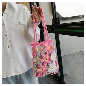 Detailed texture of handmade crochet flower tote bag with pink and white petals