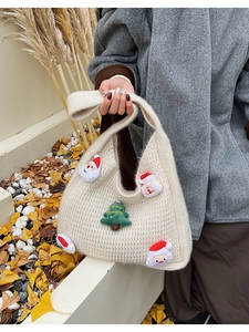 Detail of beige knitted tote bag with 3D Santa Claus and Christmas tree plush ornaments