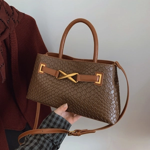 Brown crocodile embossed leather handbag with gold metal buckle and adjustable shoulder strap