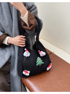 Detail view of black fleece tote bag with festive 3D Santa and Christmas tree patches