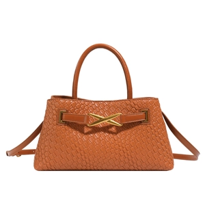 Caramel brown woven leather handbag with golden X-shaped metal buckle and top handle