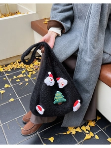 Close-up of fluffy black tote bag featuring Christmas theme patches and soft lamb wool texture