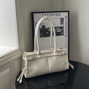 Minimalist white PU leather shoulder bag with vintage gold buckle on a black table