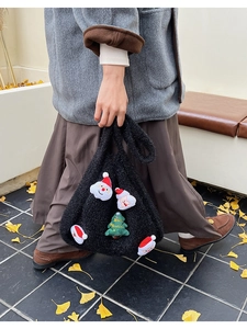 Detail of black fleece tote bag featuring 3D Santa Claus and Merry Christmas tree