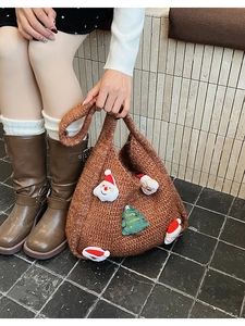 Detail of caramel knit tote bag with festive 3D Santa and Merry Christmas embroidery