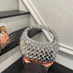 Silver metallic woven hobo bag with top handle and chain strap in minimalist style