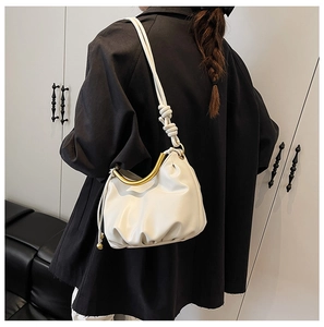 Modern white cloud bag with elegant golden metal handle and knotted strap detail