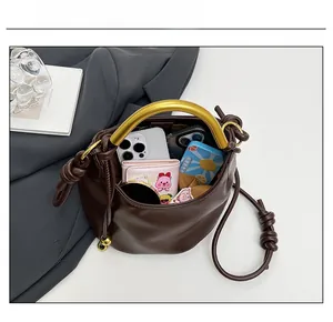 Interior view showing the large capacity of this brown pleated cloud bag for essentials