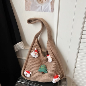 Brown woven tote bag with festive Christmas Santa and tree decorations on a suitcase