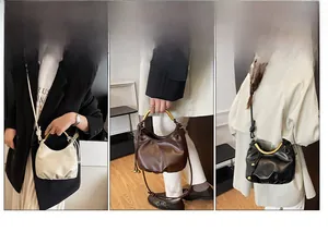 Three-way chic cloud bag showing crossbody, handheld, and shoulder styles with gold handles