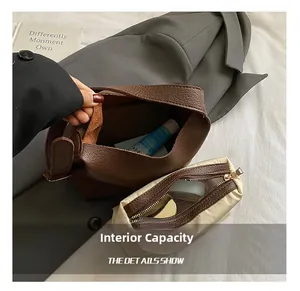 Internal capacity detail of minimalist brown leather tote with a beige fabric inner pouch