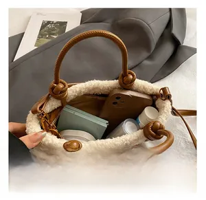 Detail showing internal capacity of check wool bucket bag with faux fur trim