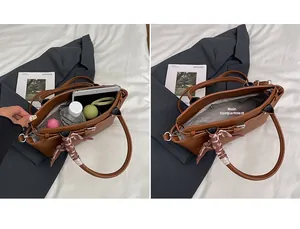 Detail view of brown pebbled leather tote bag with spacious main compartment for daily items