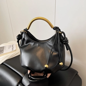 Chic black cloud bag featuring a golden semicircular handle and drawstring with metal balls
