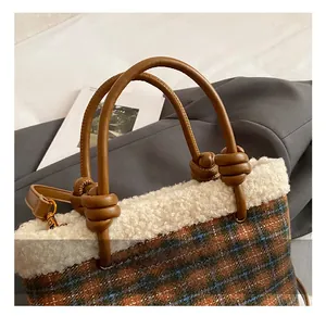 Close-up of brown plaid handbag with wool trim and knotted leather handle detail