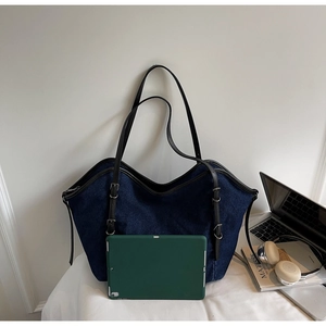 Detail of spacious denim tote bag interior showing capacity with a 10-inch tablet