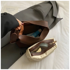 Brown lychee leather tote set with white canvas makeup pouch and gold zipper detail