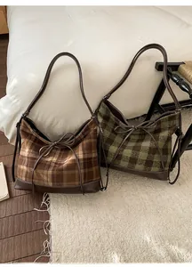Detailed close-up of brown and green plaid hobo bags with cozy plush fabric texture