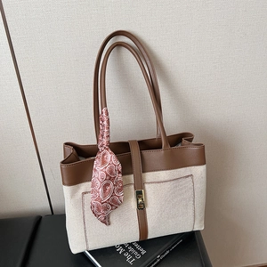 Large capacity canvas tote bag with brown leather trim and decorative silk scarf accessory