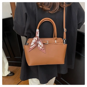 Detail of tan lychee grain tote bag with printed silk scarf and adjustable strap
