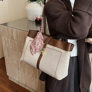 Canvas tote bag with brown leather trim and decorative silk scarf for professional women