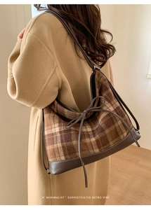 Detail of retro plaid shoulder bag with brown leather bow and stitching accents