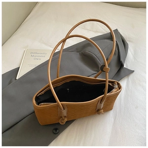Vue détaillée du sac cabas marron en cuir tressé avec bandoulière et fermeture éclair