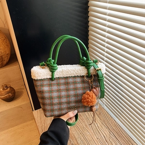 Minimalist plaid wool handbag with green knotted handle and white faux fur trim detail