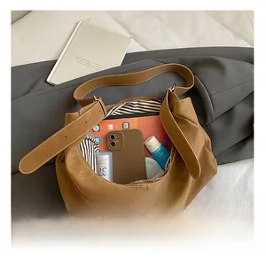 Interior view showing black and white striped lining and large capacity of suede bag