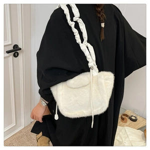 Detail of a white fuzzy plush shoulder bag with a unique ruched strap design for women